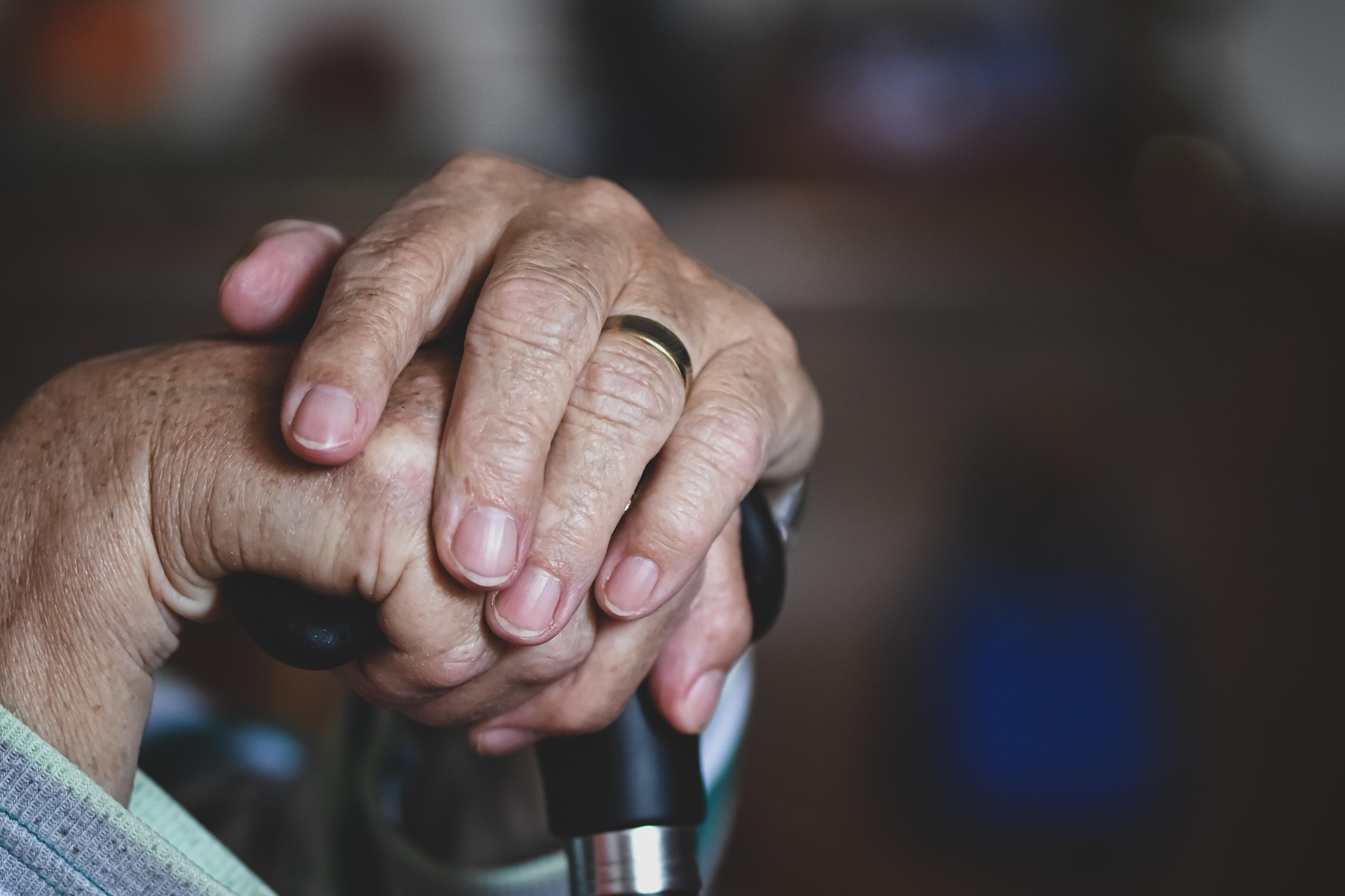 Older adult holding a cane, representing nursing home safety and elder care in Michigan